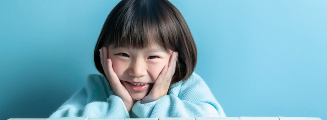 AI generated image of young girl behind blocks H Y P R L X I C